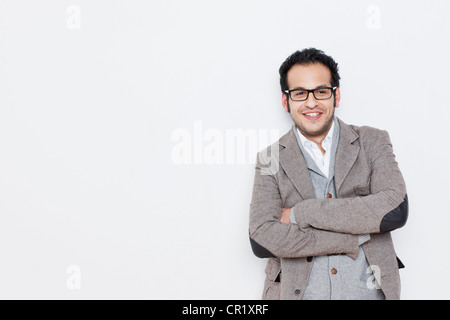 Imprenditore in piedi con le braccia incrociate Foto Stock