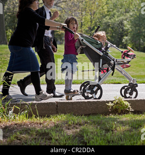 Una famiglia passeggiate attraverso Prospect Park a Brooklyn, New York su una soleggiata domenica pomeriggio. Foto Stock