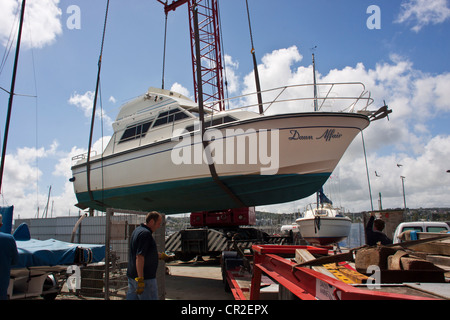 Yacht a motore (Alba Affair) essendo scaricata dal camion in marine a Torquay, Devon, Regno Unito. Foto Stock