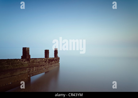 Un di legno groyne sottolineando al mare a Milford on Sea, Hampshire, Regno Unito Foto Stock