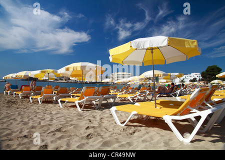 Lettini e ombrelloni sulla spiaggia di Es Canar, Ibiza, Isole Baleari, Spagna, Europa Foto Stock