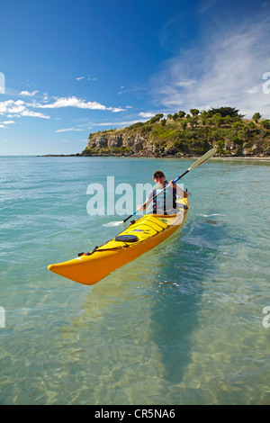 Kayak di mare dalla spiaggia vicino punto di medici e Mapoutahi Pa, Storico Pa maori sito, a nord di Dunedin, Isola del Sud, Nuova Zelanda Foto Stock