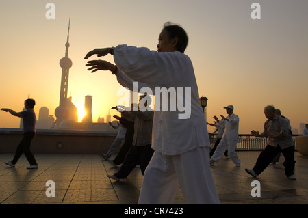 Persone che praticano il Tai Chi sul Bund all'alba a Shanghai in Cina Foto Stock