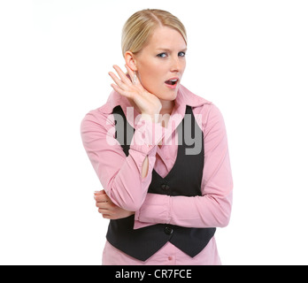 Curioso donna cercando di sentire qualcosa Foto Stock