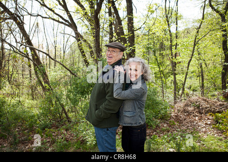 Coppia senior in piedi insieme nella foresta, ritratto Foto Stock