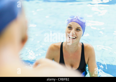 Nuotatori parlando in piscina Foto Stock