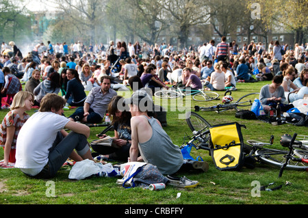 I campi di Londra grande gruppo di persone sedute sull'erba nel sul weekend di primavera Foto Stock