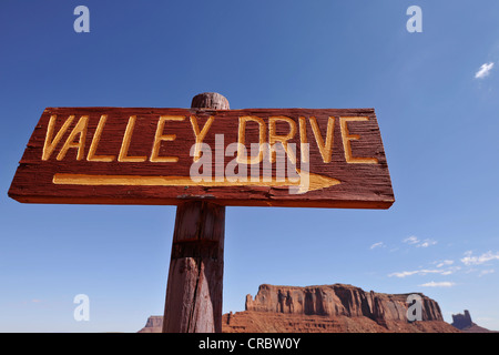 Segno Valley Drive nella parte anteriore del Sentinel Mesa e il castello di Butte tabella montagne, Monument Valley Navajo Tribal Park Foto Stock