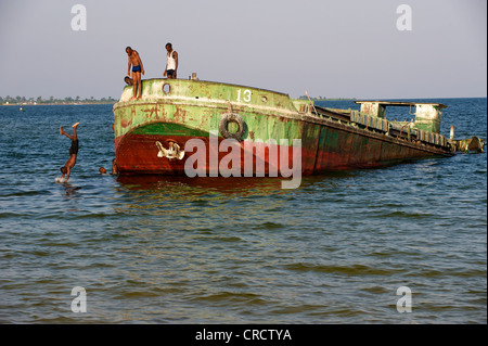 Bambini che giocano in una chiatta abbandonati sul lago Victoria, Bukoba, Tanzania Africa Foto Stock