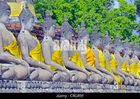 Statue di Buddha attorno alla grande Chedi Chaya Mongkol, Thailandia, Ayutthaya, Wat Yai Chai Mongkon Foto Stock