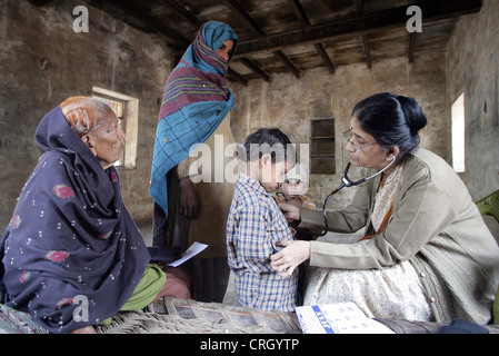 Medico Volontario (destra) esamina malati abitanti di un villaggio in India senza alcun costo/royalty Foto Stock