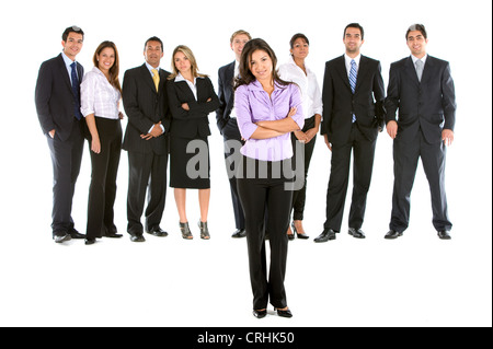 Giovane imprenditrice in piedi nella parte anteriore del suo team, con bracci ripiegati Foto Stock