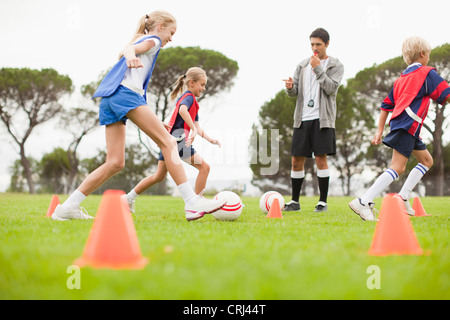 Coach training per bambini squadra di calcio Foto Stock