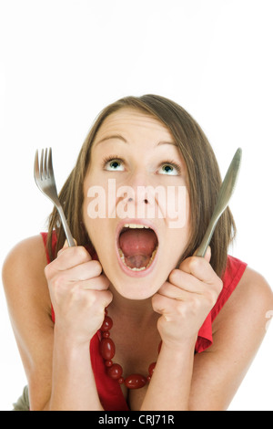 Fame donna con forcella coltello ans Foto Stock