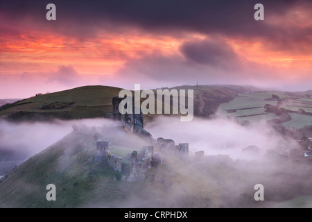 Le rovine di Corfe Castle Rising attraverso la nebbia di mattina. Foto Stock