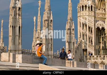 I turisti tra le guglie e statue del Duomo (Cattedrale di Milano) tetto, Milano, Lombardia, Italia Foto Stock