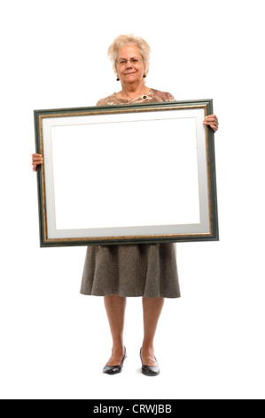 Donna di mezza età tenendo cornice immagine Foto Stock