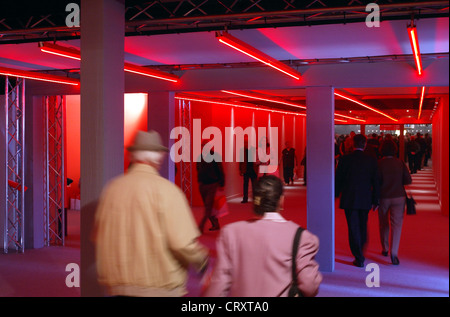La gente passare attraverso un ingranaggio rosso, e.on AGM a Essen Foto Stock