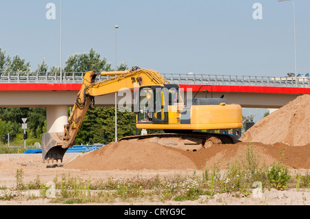 Escavatore giallo su una collina Foto Stock