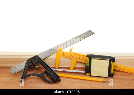 Selezione di oggetti in legno degli strumenti di misurazione sul legname contro uno sfondo bianco Foto Stock