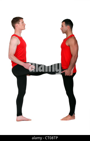 Due maschio ginnasti stretching Foto Stock