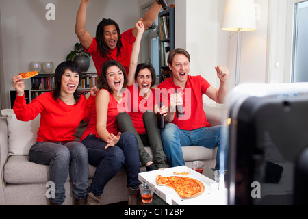 Gli amici a guardare lo sport in TV Foto Stock