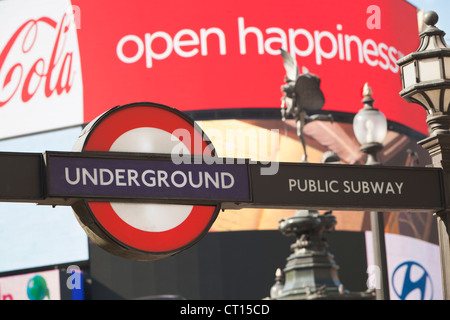 La metropolitana di Londra segno con la pubblicità visualizza in Piccadilly Circus, London, Regno Unito Foto Stock