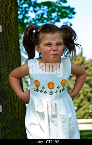 Quattro anni di bambina rendendo divertente volto Foto Stock