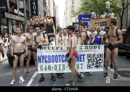 Gli uomini pubblicizzare per NYC Boot Camp una formazione e una palestra per il fitness a New York presso il Gay Pride Parade Foto Stock