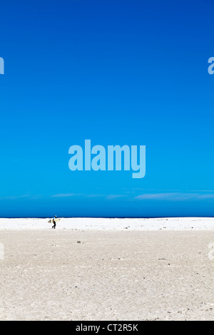 Surfer camminando sulla spiaggia Noordhoek, Sud Africa Foto Stock