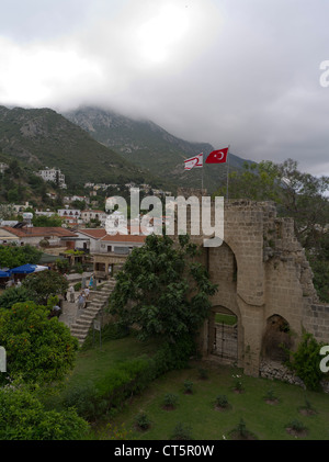 dh Abbazia di Bellapais KYRENIA CIPRO SETTENTRIONALE Bellapais Abbazia rovine bandiere turche e Besparmak catena montuosa nord Foto Stock