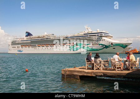 I turisti mangiare all'aperto di fronte al Jade norvegese nave da crociera, Katakolon, Grecia Foto Stock