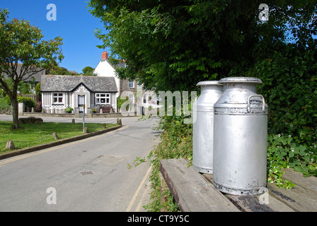 Bidoni per il latte dal ciglio della strada nel villaggio di crantock in cornwall, Regno Unito Foto Stock