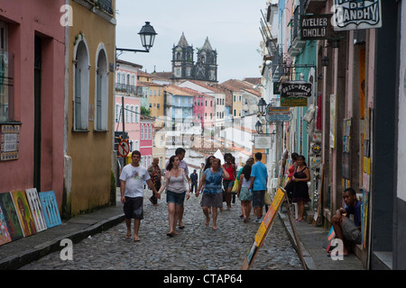 La gente a piedi su Pelourinho old town street con Igreja do Santissimo Sacramento fare il passo chiesa, Salvador, Bahia, Brasile, Sud un Foto Stock