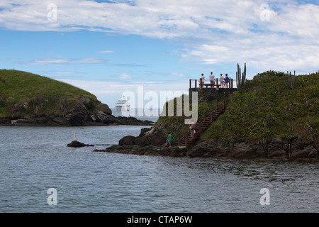 Le persone sulla piattaforma costiera con la nave da crociera MS Deutschland, Reederei Peter Deilmann, in distanza, Cabo Frio, Rio de Janeiro, Bra Foto Stock