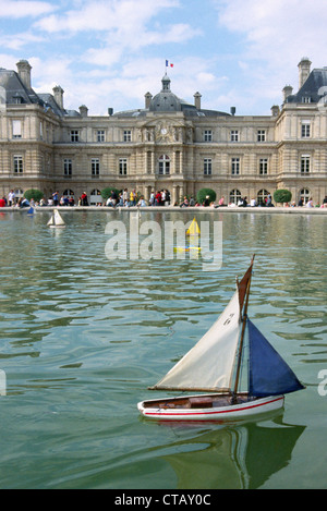 La barca a vela giocattoli nella fontana nel giardino di Lussemburgo, Parigi Francia con il palazzo in background. Jardin du Luxembourg. Foto Stock