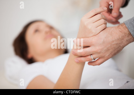 La mano di una donna di essere manipolato Foto Stock