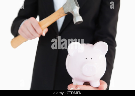 Piggy-bank sarà rompere con un martello Foto Stock
