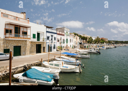 Piccole barche da pesca ormeggiate accanto al case in Portocolom, Mallorca/Maiorca Foto Stock