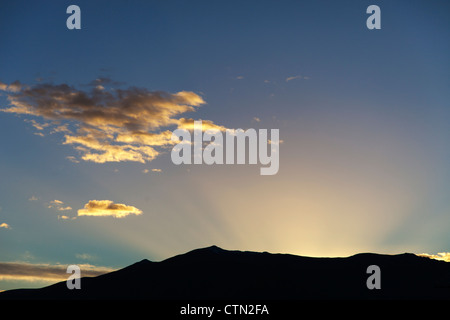 Il sorgere del sole dietro le colline, Omarama, Isola del Sud della Nuova Zelanda Foto Stock