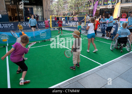 I bambini a giocare a tennis e badminton a 'su i vostri marchi " eventi sportivi nel corso del 2012 Olympics CARDIFF CITY CENTRE KATHY DEWITT Foto Stock