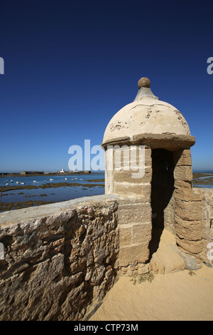 Città di Cadiz, Spagna. Guard torre di avvistamento nel Castillo de Santa Catalina con il Castello di San Sebastian in background. Foto Stock