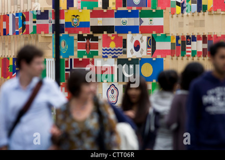 I visitatori di Londra per le Olimpiadi del 2012 ammirare la Casa delle bandiere' una struttura di 206 pannelli contenenti la bandiera le icone di tutti i paesi che partecipano a Londra nel 2012 Olimpiadi e Paraolimpiadi invernali. Progettato da architetti AY, la struttura si trova di fronte al Palazzo di Westminster in piazza del Parlamento. Foto Stock