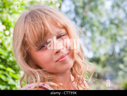 Ritratto di un sorridente leggermente piccola bionda bella ragazza Russa al di sopra della natura sfondo all'aperto Foto Stock