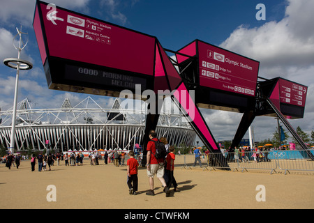 Arrivano gli spettatori passano sotto il grande gateway per il parco olimpico durante le Olimpiadi di Londra 2012. Questa terra è stata trasformata in un 2.5 sq km complesso sportivo, una volta che le imprese industriali ed ora sede di otto luoghi di interesse tra cui il principale arena, Aquatics Centre e Velodromo plus degli atleti del Villaggio Olimpico. Dopo le Olimpiadi, il parco è noto come Queen Elizabeth Olympic Park. Foto Stock