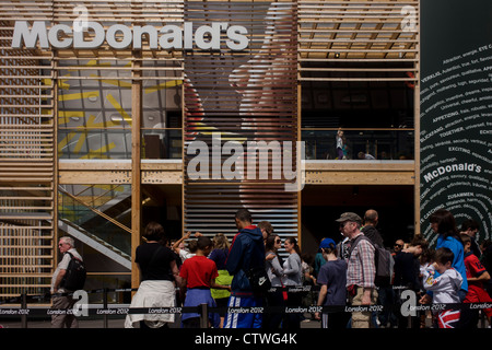 Spettatori cenare al di fuori di tutto il mondo più grande McDonald's nel Parco Olimpico durante le Olimpiadi di Londra 2012. Centinaia di punti vendita alimentari a luoghi Olimpici sono stati costretti a prendere chips fuori il menu, a causa di una richiesta da sponsor McDonald's. Olympic chiefs vietati tutti i 800 dettaglianti alimentari a 40 sedi di giochi in tutta la Gran Bretagna da incavature su chip a causa di 'sponsorship obblighi. Foto Stock