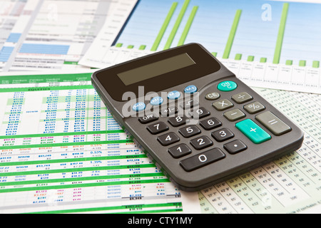La calcolatrice sulla parte superiore dei grafici di business, grafici, i budget e i fogli di calcolo Foto Stock