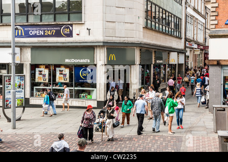 Agli acquirenti di passare da un ristorante mcdonalds sulla st peter's Gate, Nottingham. un caldo giorno d'estate e di sole. Foto Stock