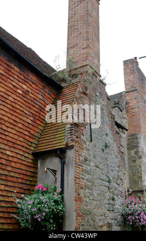 Mattoni vecchi e camino in pietra sulla casa a Petworth. West Sussex. Inghilterra Foto Stock