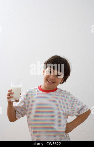 Ritratto di un ragazzo con in mano un bicchiere di latte Foto Stock